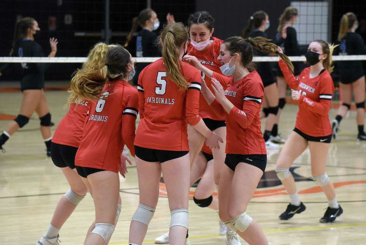The Greenwich Cardinals celebrate after defeating Darien 3-1 in the CIAC Class LL girls volleyball semifinals in Stamford on Wednesday.