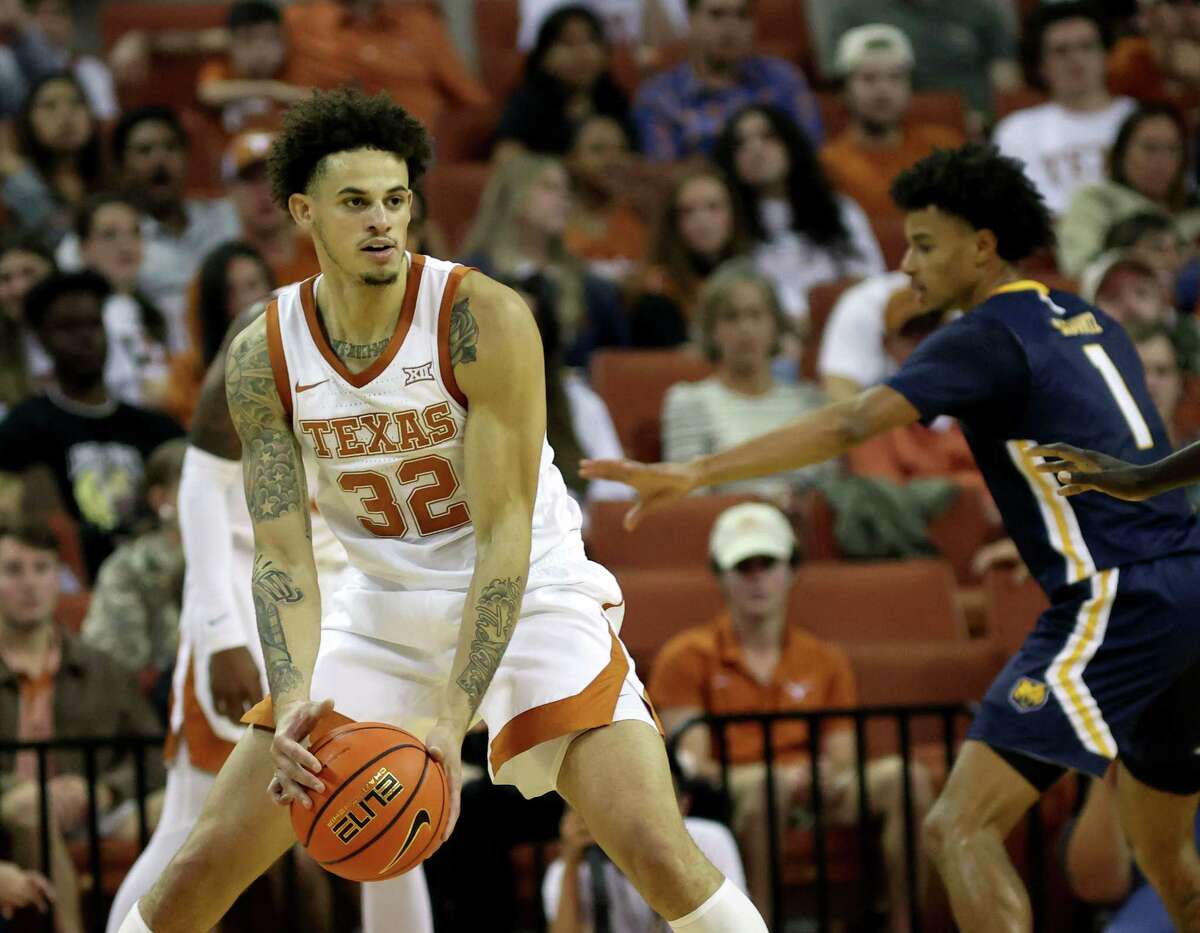 AUSTIN, TEXAS - NOVEMBER 17: Christian Bishop #32 of the Texas Longhorns holds the ball away from Daylen Kountz #1 of the Northern Colorado Bears during the first half at Erwin Center on November 17, 2021 in Austin, Texas.