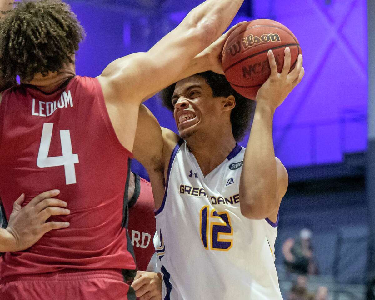 UAlbany freshman Justin Neely drives to the basekt in front of Harvard University junior Chris Ledlum at the SEFCU Arena on the UAlbany campus on Wednesday, Nov. 17, 2020. (Jim Franco/Special to the Times Union)
