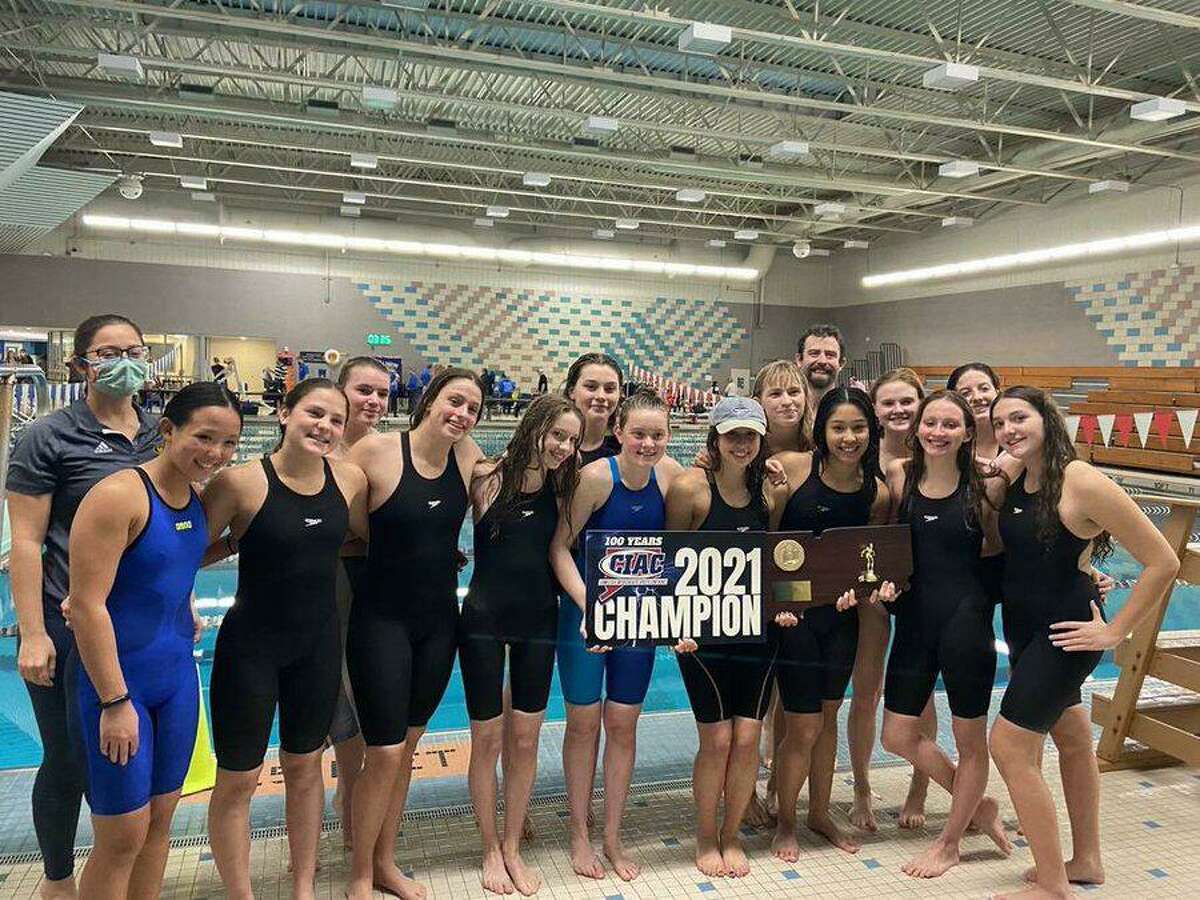 Members of the Weston girls swimming and diving team celebrate their eighth straight state championship Wednesday after winning the Class S title at Cornerstone Aquatics Center in West Hartford.