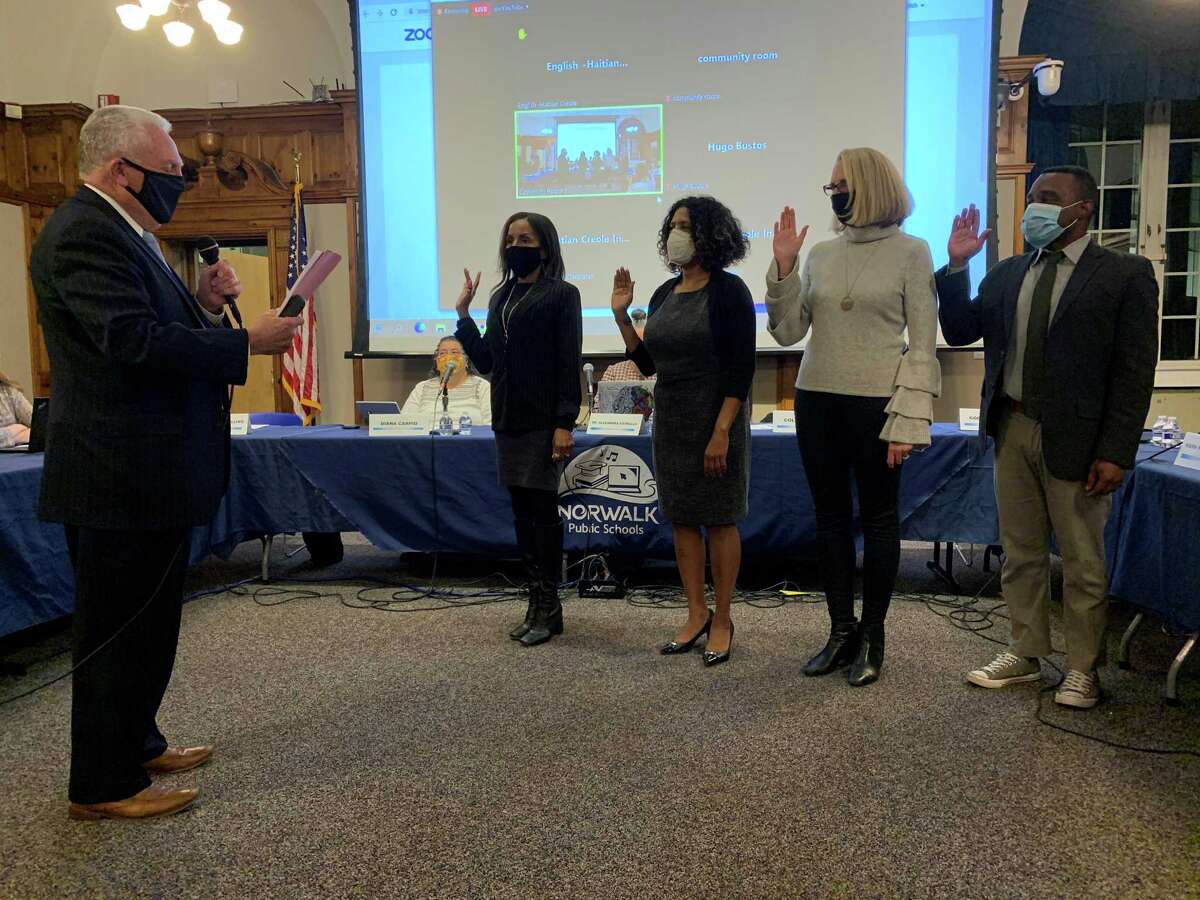 Mayor Harry Rilling delivers the oath of office to new board members Sheri McCready Brown, Janine Randolph, and Kara Baekey as well as incumbent Colin Hosten. Each member was elected onto the board for the first time in November.