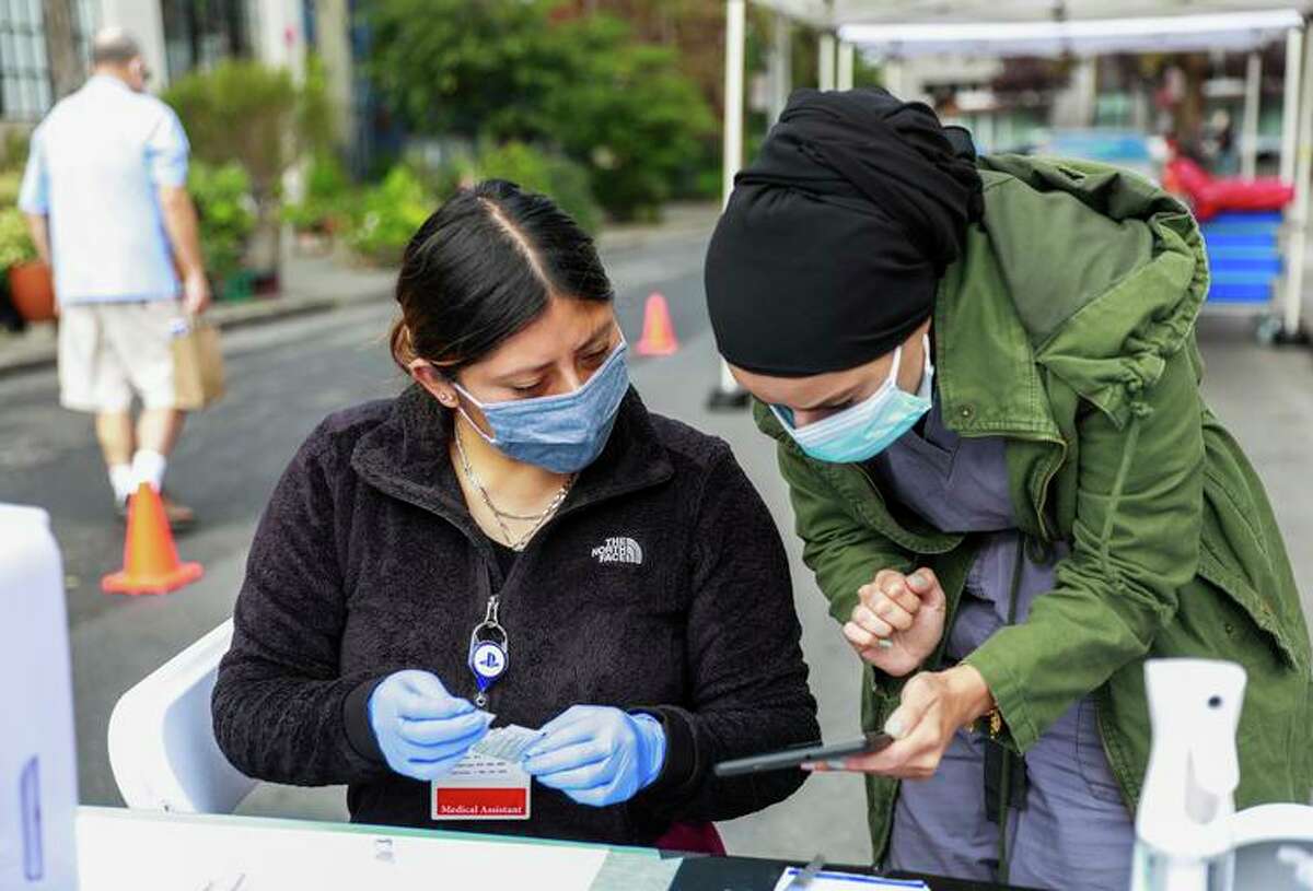Medical assistants give out COVID-19 boosters at a pop-up vaccine clinic on Nov. 4 in San Francisco.