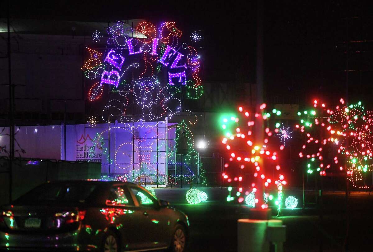 Cars drive a circuit of holiday lights and music during the opening night of the Holiday Lights Spectacular at the Hartford Healthcare Amphitheater in Bridgeport, Conn. on Wednesday, November 17, 2021.