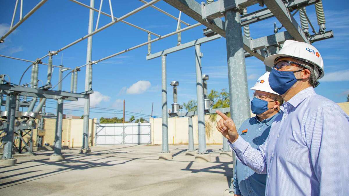 Fred Bonewell, left, then CPS chief security, safety and gas solutions officer, stands with Richard Medina, CPS vice president of grid transformation and engineering, last year at a power substation.