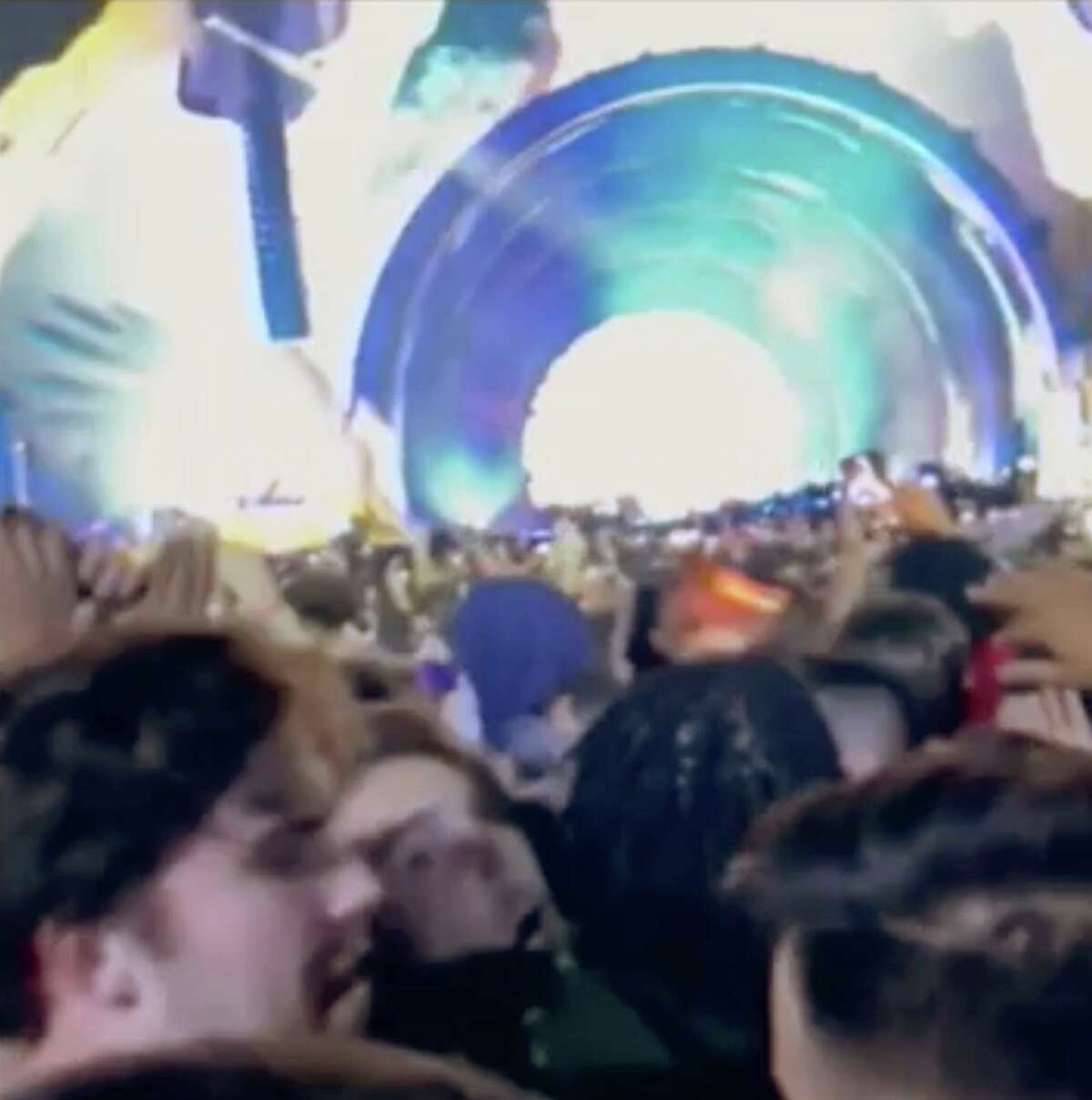 In this image from a cellphone video provided by Gabe Casey, fans attending a performance by rapper Travis Scott shout to people to “back up” during the Astroworld Festival on Nov. 5.