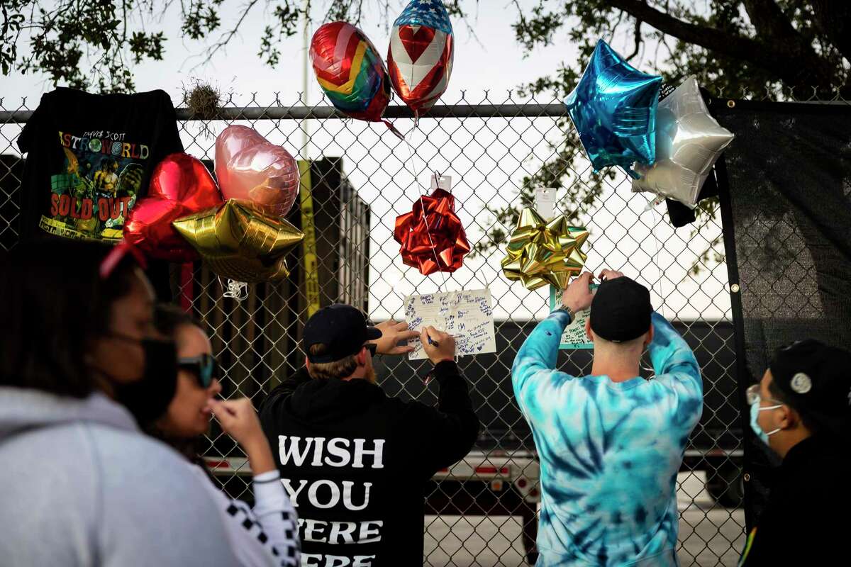 People post messages to victims on a gate outside the Astroworld Festival site in Houston during a vigil on Nov. 6.