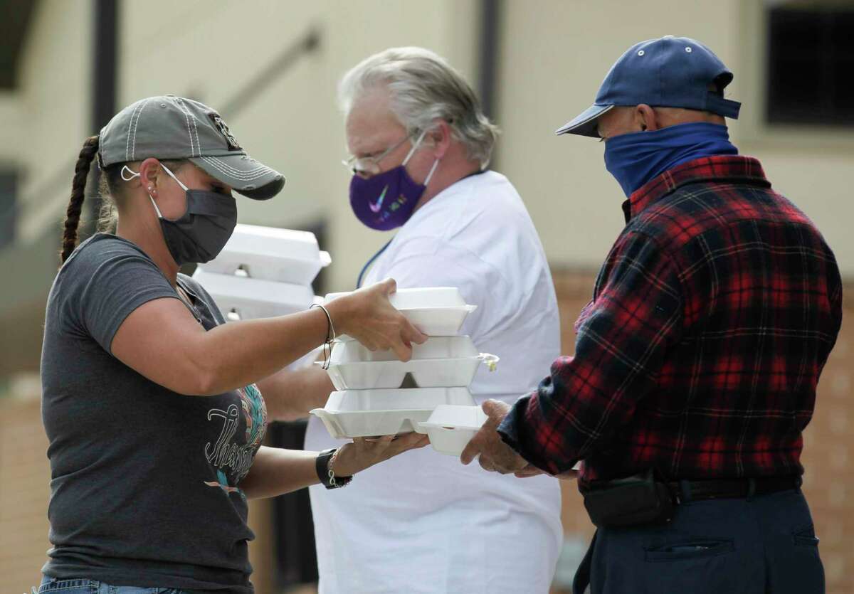 Trisha Miller hands out meals as The Salvation Army and Friends of Conroe partnered for the annual Friends Feeding Friends Thanksgiving meal, Thursday, Nov. 26, 2020, in Conroe.