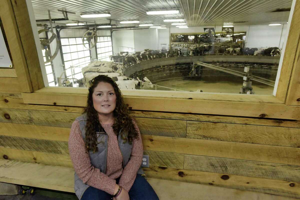 Crystal Grimaldi, a partner in her family's farm, Ideal Dairy Farms, sits in the viewing area above the rotary milking parlor on Thursday, Nov. 11, 2021, in Hudson Falls, N.Y. The rotary parlor allows workers to milk between 400 to 500 cows an hour.