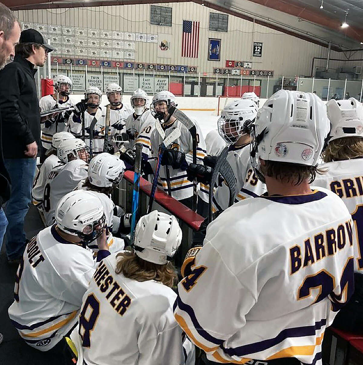 Bethalto head coach Brett Settles, left, speaks to his team between period of a recent game at the East Alton Ice Arena.