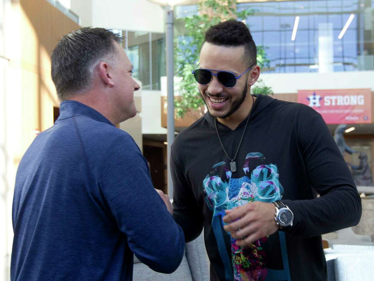 Houston Astros manager AJ Hinch, left, greets Carlos Correa beside his fiance Daniella Rodriguez during a stop as part of the Astros Caravan, Friday, Jan. 12, 2018, in The Woodlands.