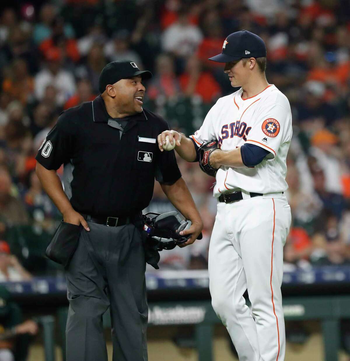 Houston Astros starting pitcher Zack Greinke (21) chats with home plate umpire Adrian Johnson during the fifth inning of an MLB baseball game at Minute Maid Park, Monday, Sept. 9, 2019, in Houston.