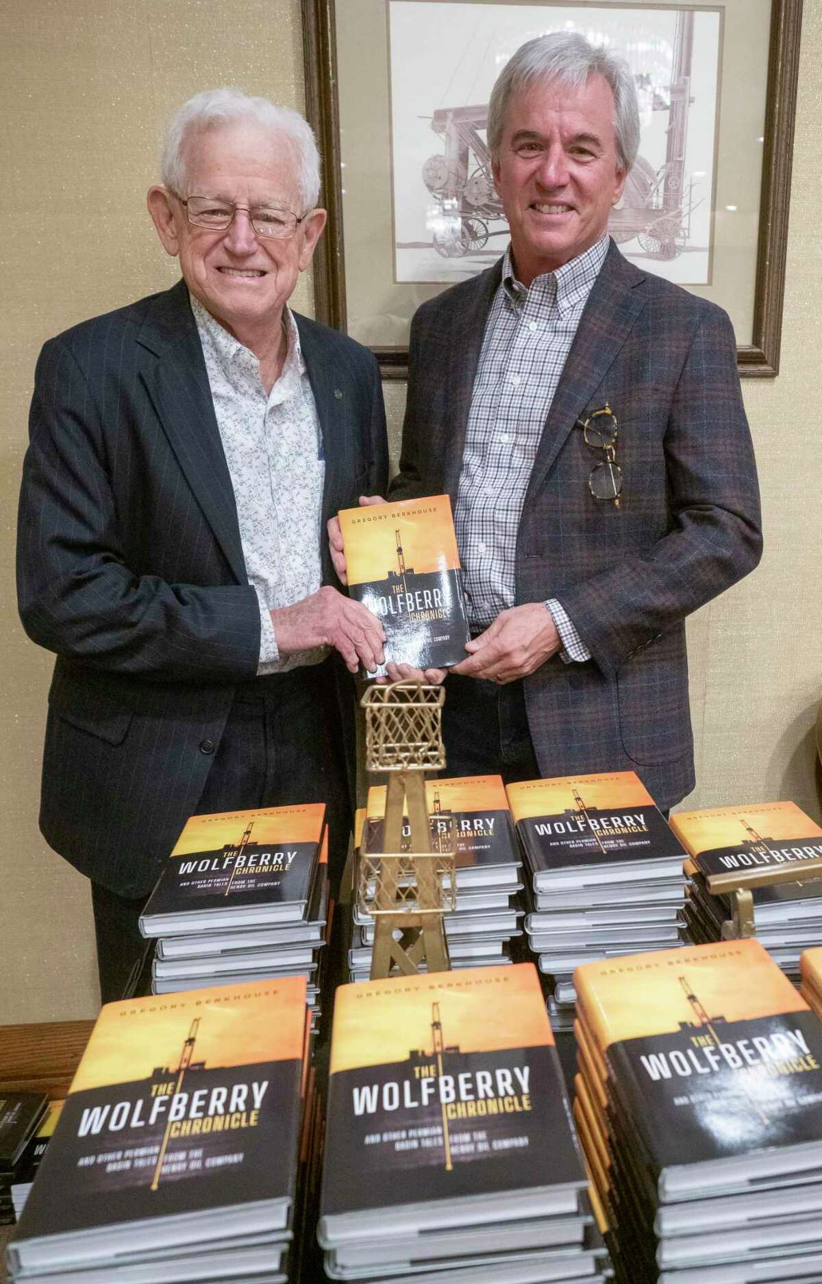 Jim Henry and author Gregory Berkhouse with their book "The Wolfberry Chronicles" at a reception 11/18/2021 at the Petroleum Clun. Tim Fischer/Reporter-Telegram