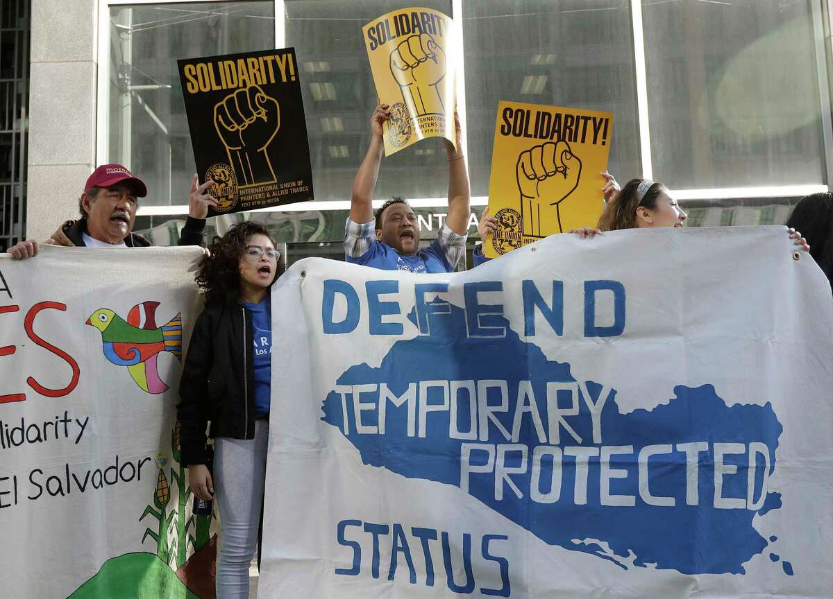 Supporters of temporary protected status immigrants hold signs and cheer at a rally before a news conference announcing a lawsuit against the Trump administration over its decision to end a program that lets immigrants live and work legally in the United States outside of a federal courthouse in San Francisco, Monday, March 12, 2018. Plaintiffs alleged the decision to end temporary protected status for El Salvador, Haiti, Nicaragua and Sudan was racially motivated. (AP Photo/Jeff Chiu)