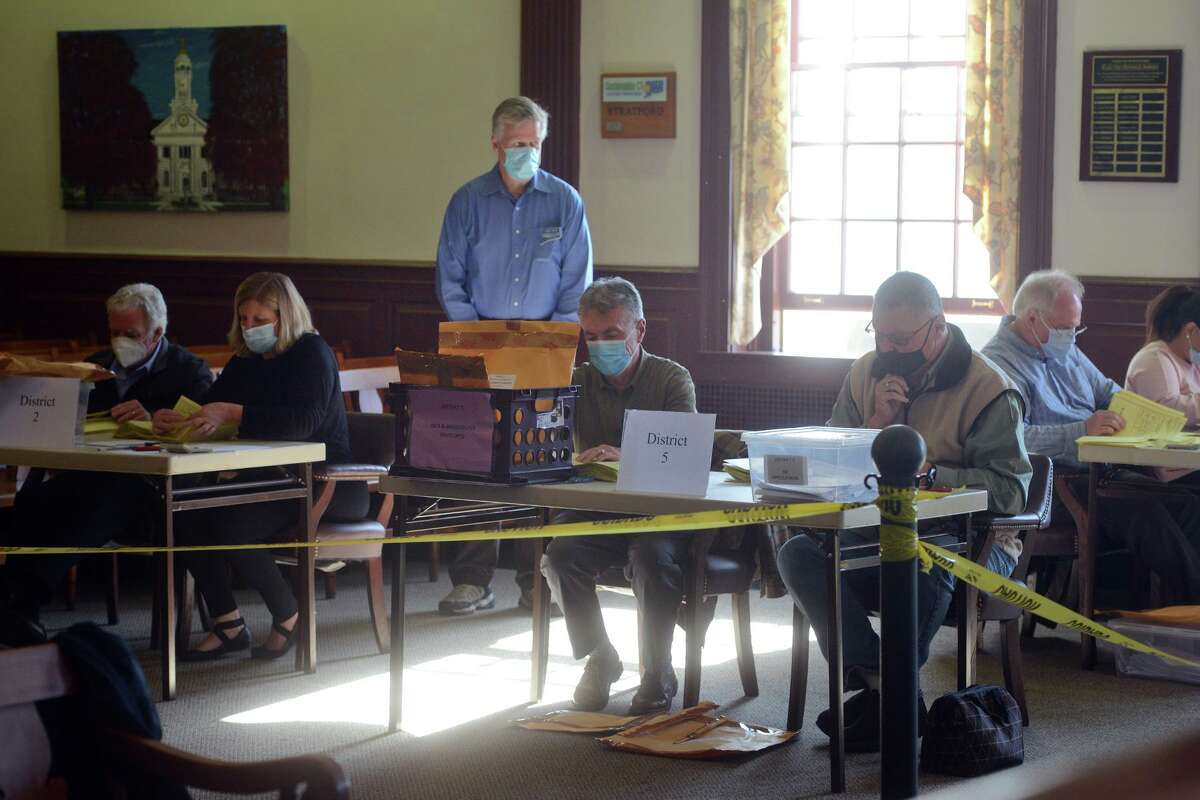 Officials work to recount ballots from the Nov. 2 election in Stratford, Conn. Nov. 8, 2021.