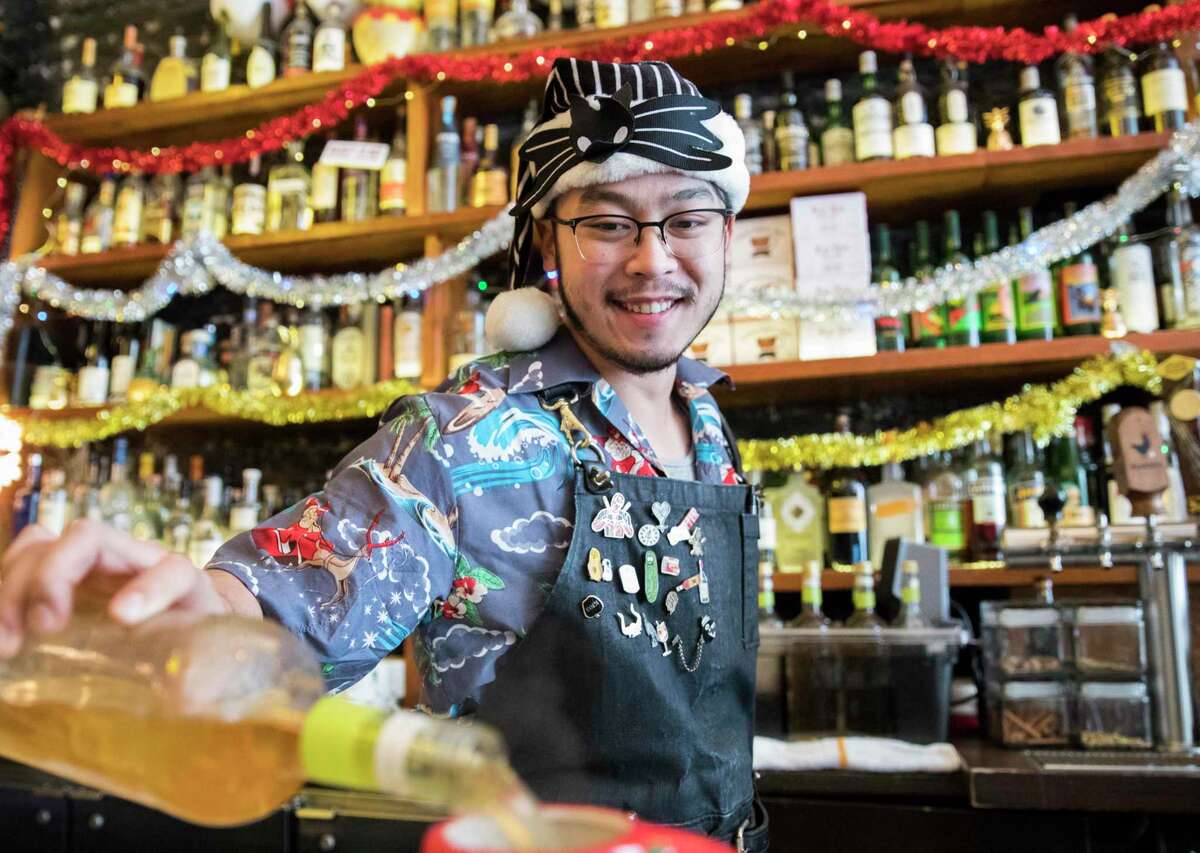 Bartender Garrett Hom pours a Bad Santa cocktail at Pacific Cocktail Haven’s Christmas-theme Miracle pop-up in 2018.