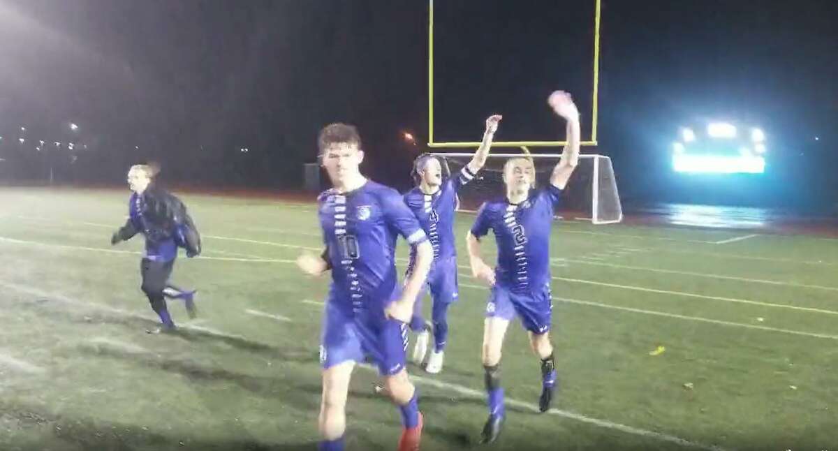 Members of the Old Saybrook boys soccer team celebrate their Class S semifinal victory over Somers Thursday. Old Saybrook won 5-3 in overtime.