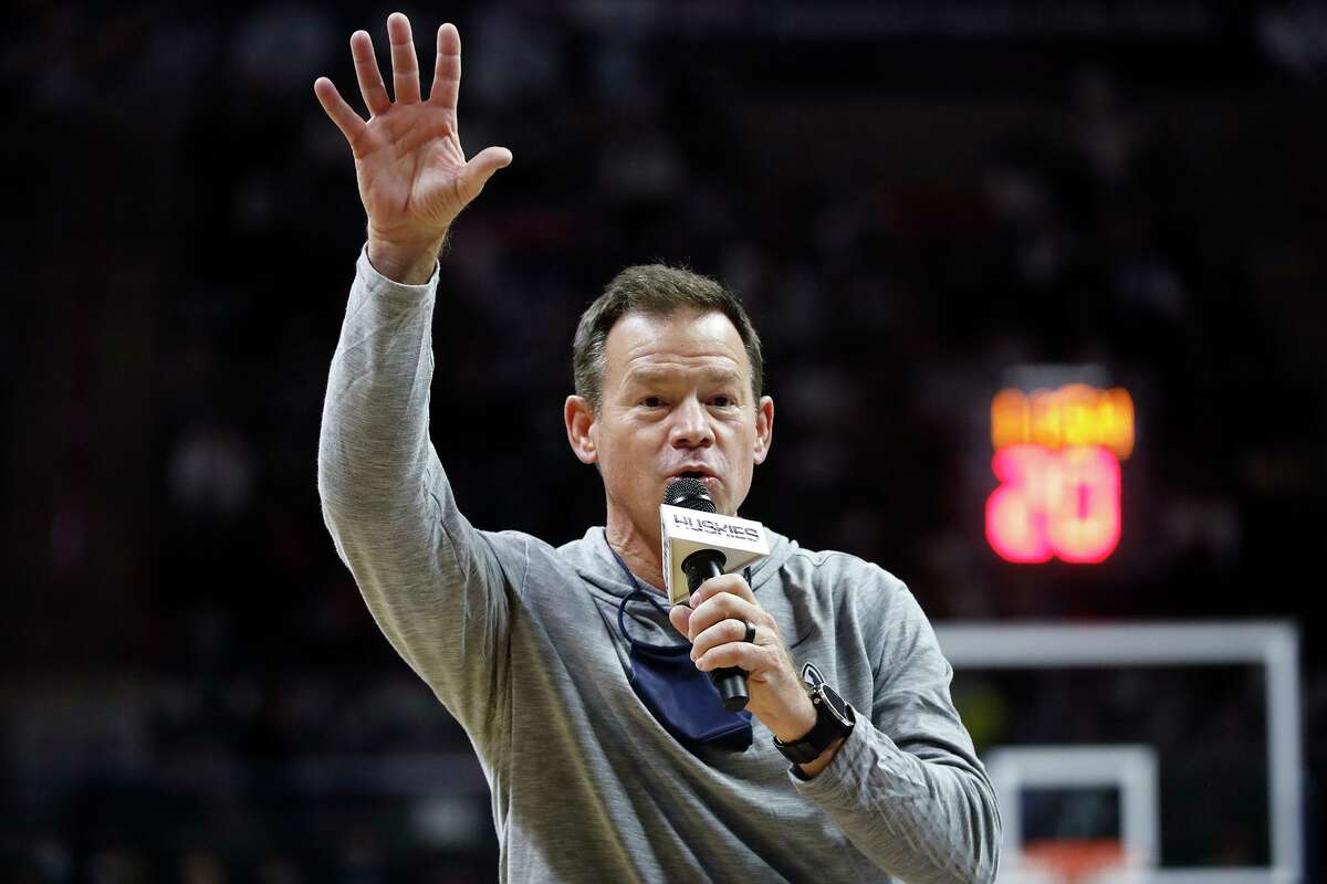 Connecticut football coach Jim Mora addresses basketball fans during a timeout in the game between Connecticut and Long Island at the University of Connecticut Wednesday Nov. 17, 2021, in Storrs, Conn.(AP Photo/Paul Connors)