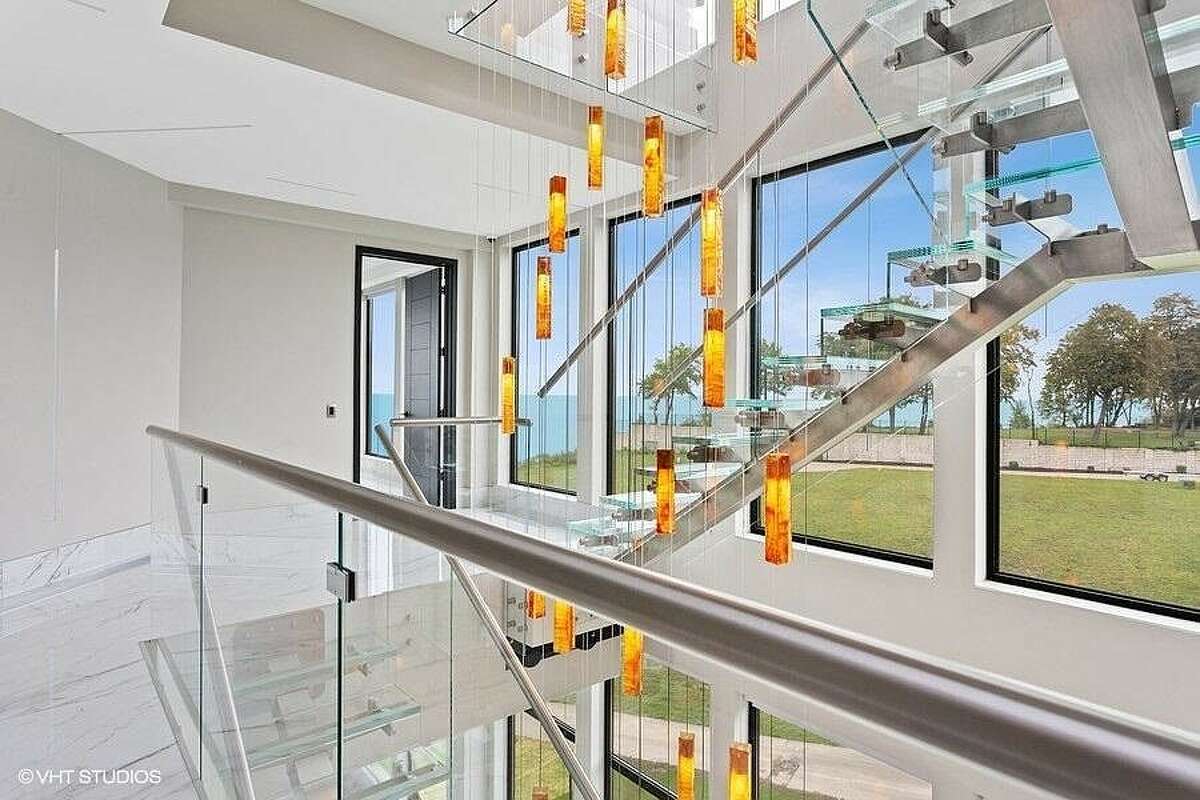Ornate glass staircase with lights.