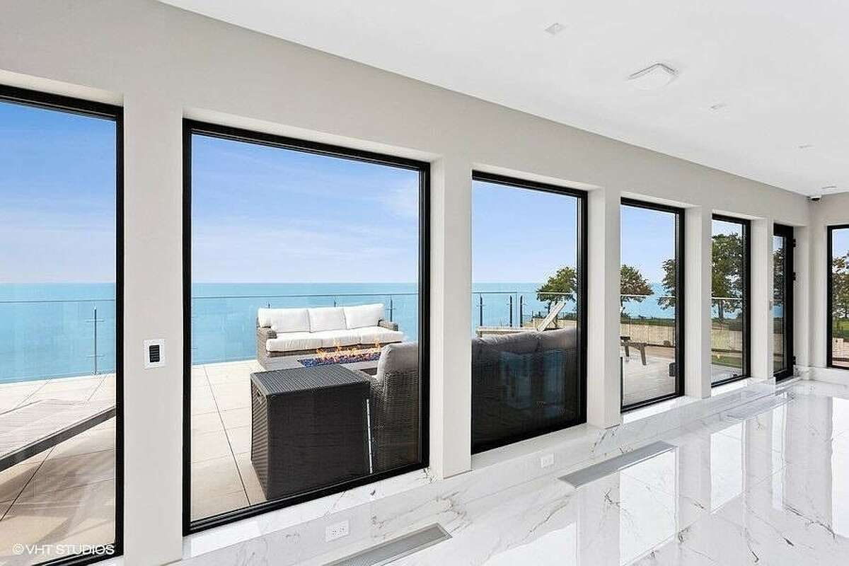 View of rooftop deck through floor-to-ceiling windows.