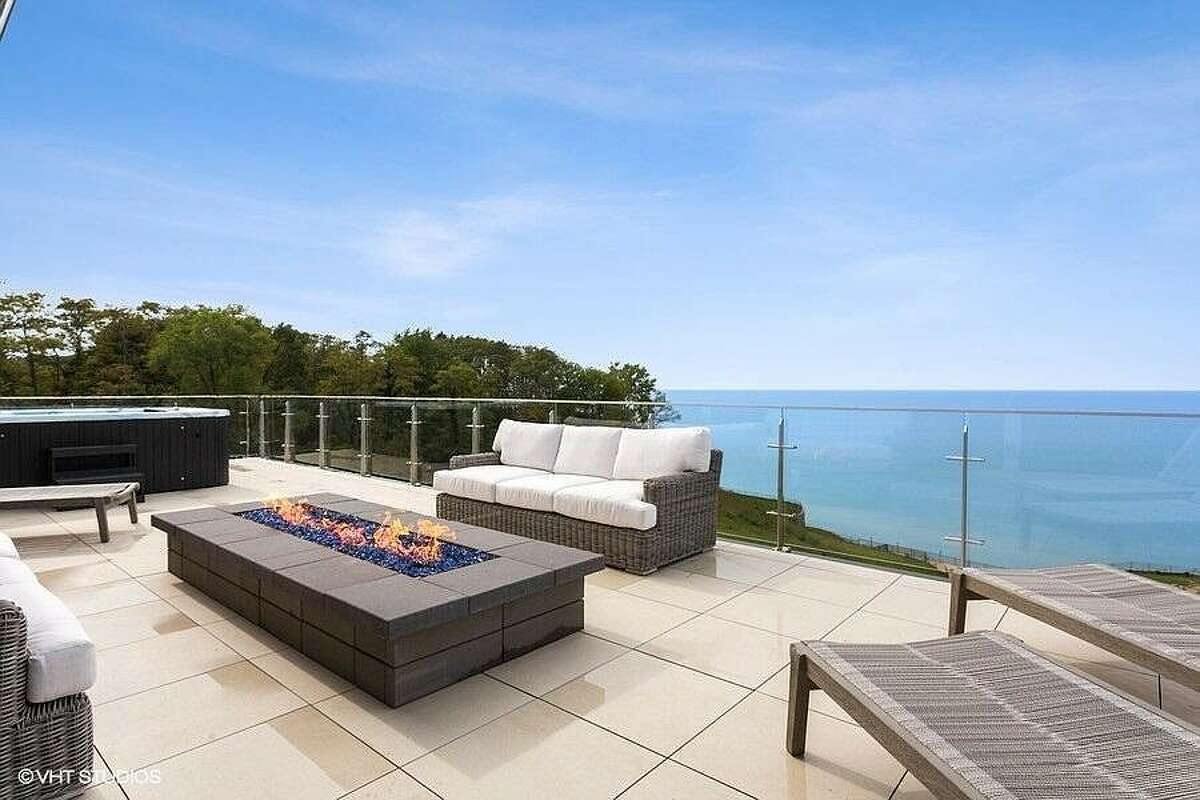 Rooftop deck with fireplace and view of Lake Michigan.