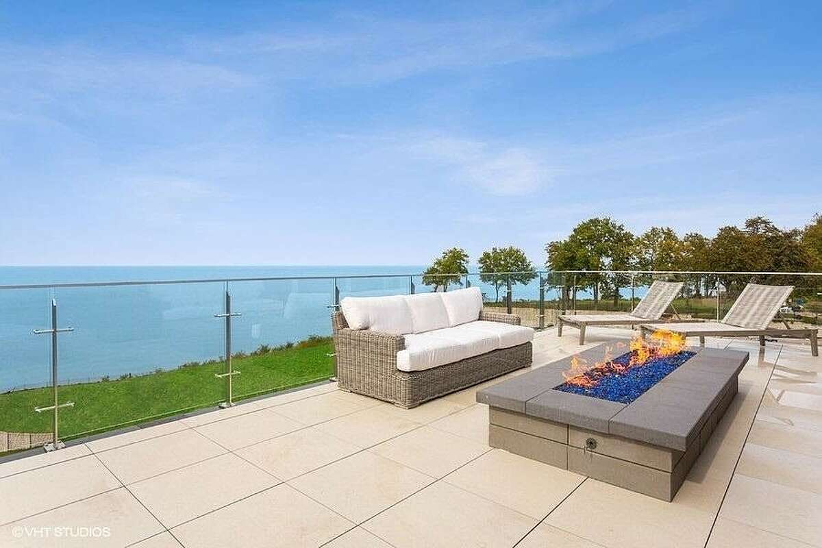 Rooftop deck with seating and fireplace.