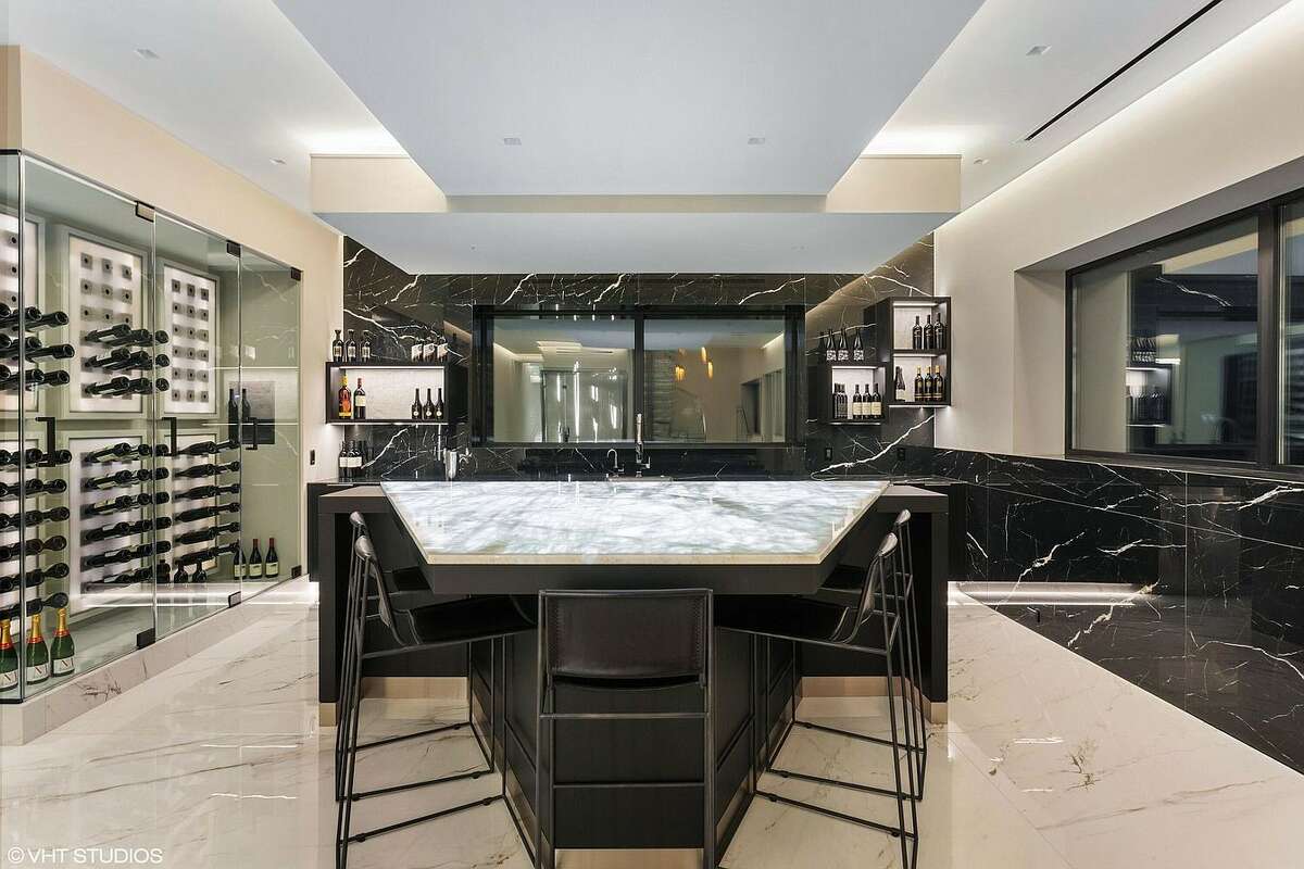 Bar area with wine cellar at night.