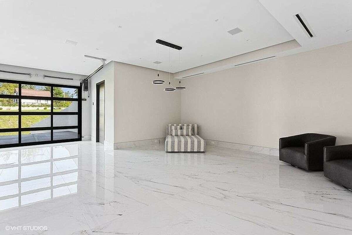 Open area with seating and overhead door to the outside.