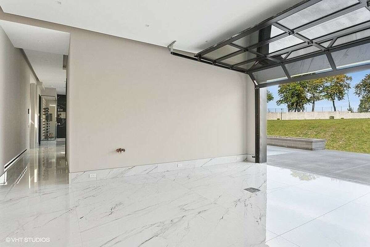 Open area with marble flooring and overhead door.