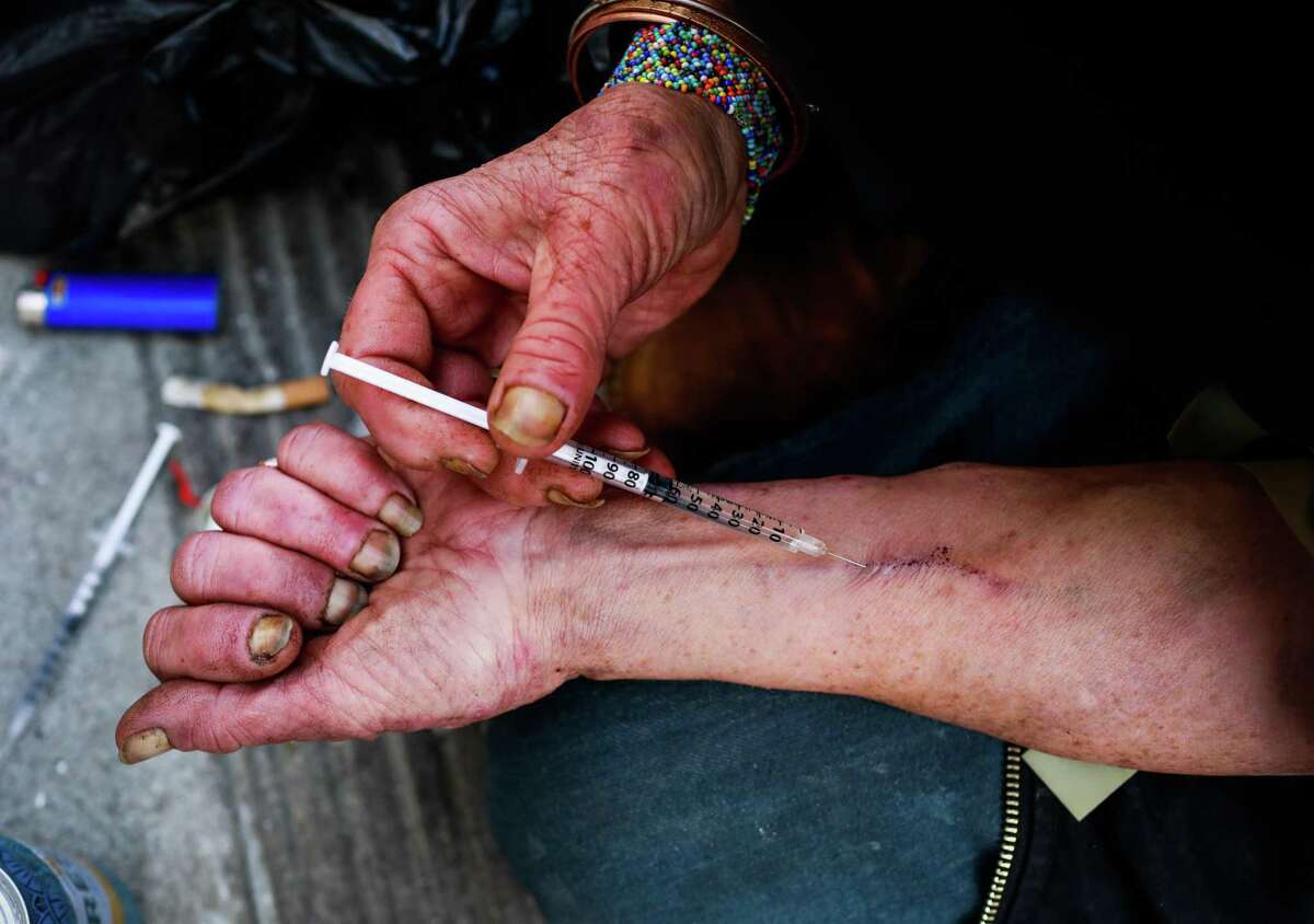Rebecca Byrd, 58, uses fentanyl in Willow Alley on Thursday, Nov. 18, 2021 in San Francisco, California. She liked the idea of having a supervised drug use site.