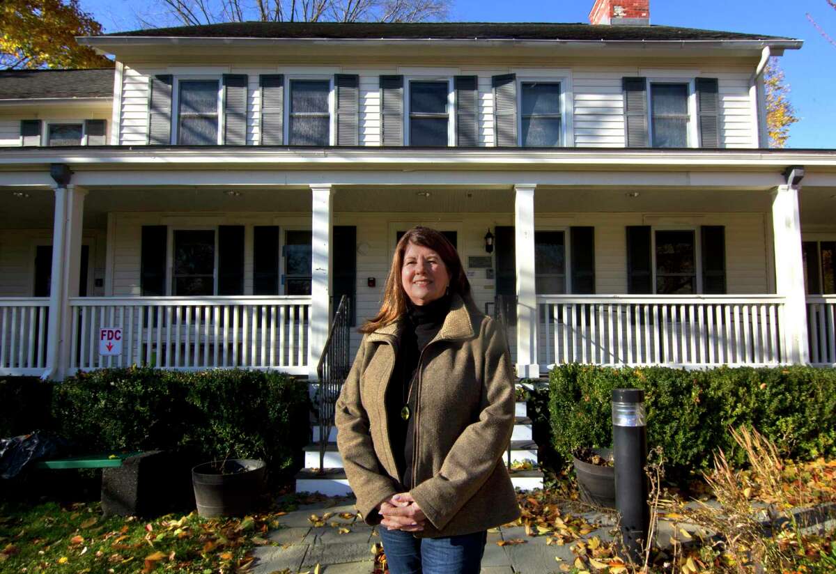 Kids in Crisis Managing Director Denise Qualey stands in front of the organization's outreach health center in Greenwich, Conn., on Friday November 19, 2021. Since the COVID-19 pandemic, a lot more children are seeking help for mental health problems.