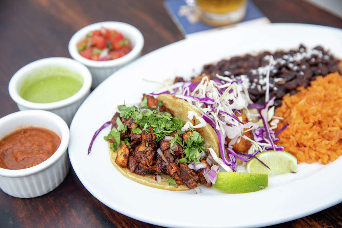 A taco plate, include mole chicken and fish, is one of the specialties at Smiley's Saloon.
