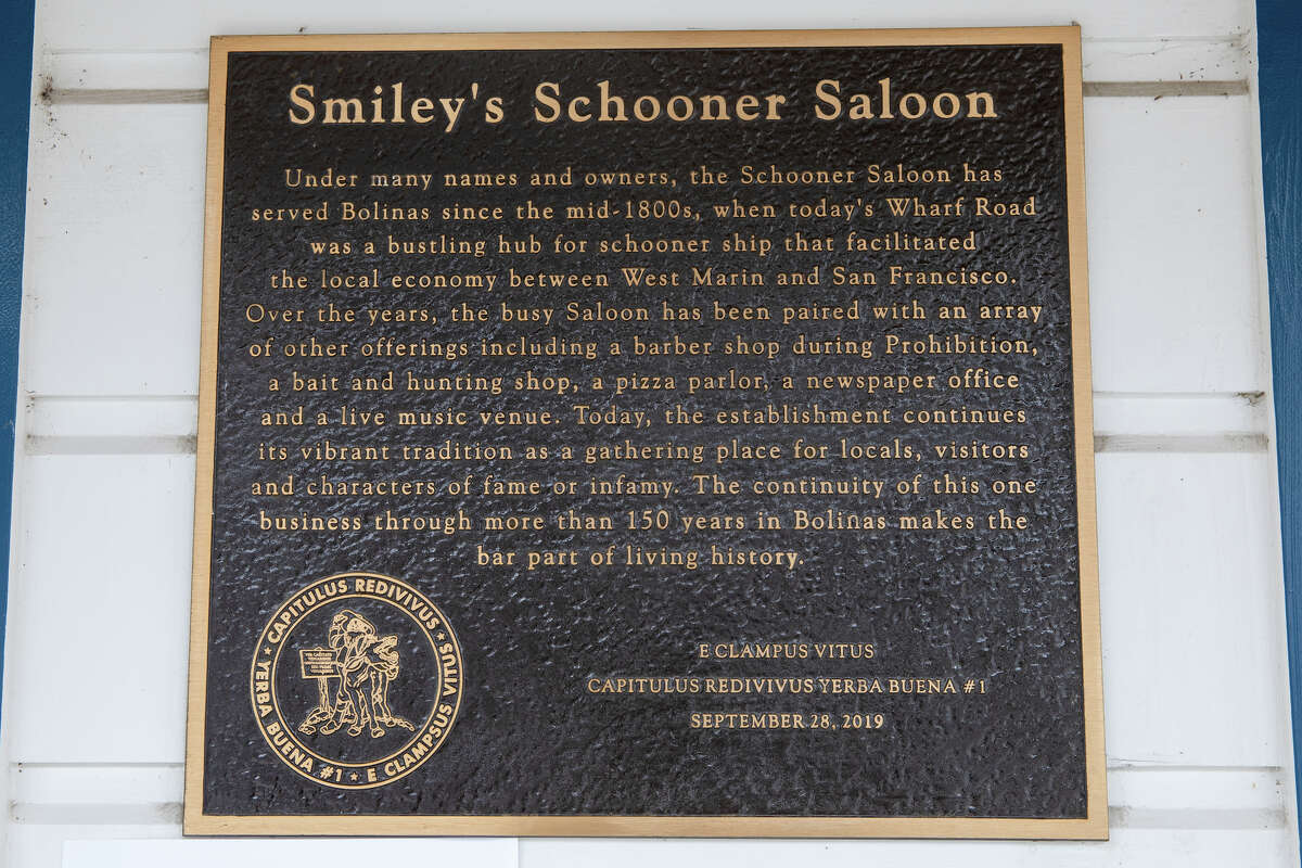 A historical placard recounts the history of Smiley's Saloon in Bolinas, California.