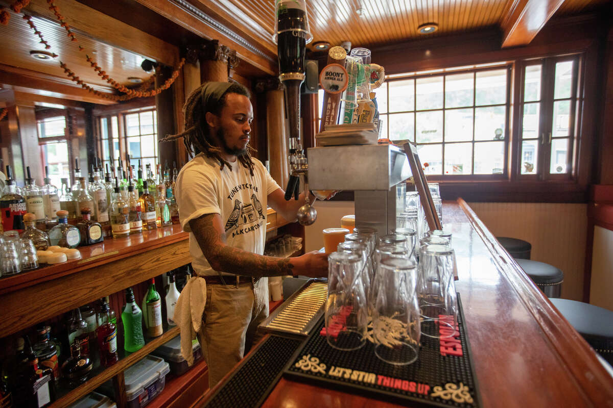Bartender Frederick Newbill pours a drink at Smiley's Saloon.
