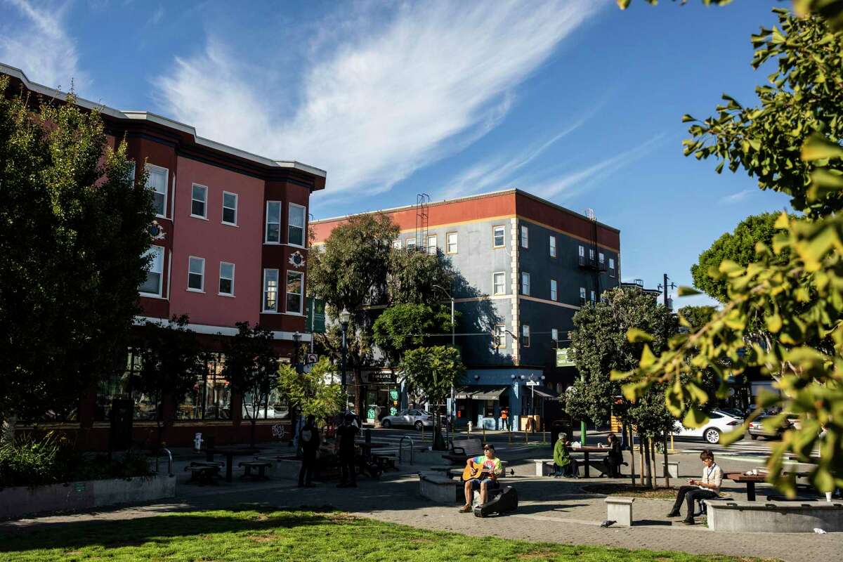 Marcos Chimes plays a guitar in Patricia’s Green in the Hayes Valley neighborhood of San Francisco.
