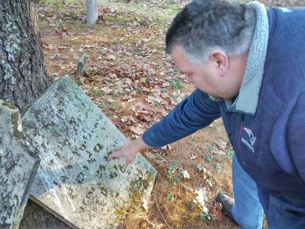 Winsted Mayor Todd Arcelaschi at the Danbury Quarter Road cemetery, one of the town's oldest burial sites near Winchester Center. It is inaccessible, mostly because of the condition of the dirt road, filled with potholes, standing water and deep ruts, as well as steep inclines. But the mayor wants to find a way to record who is buried there, clean up the one-acre property and possibly repair some of the many broken headstones.