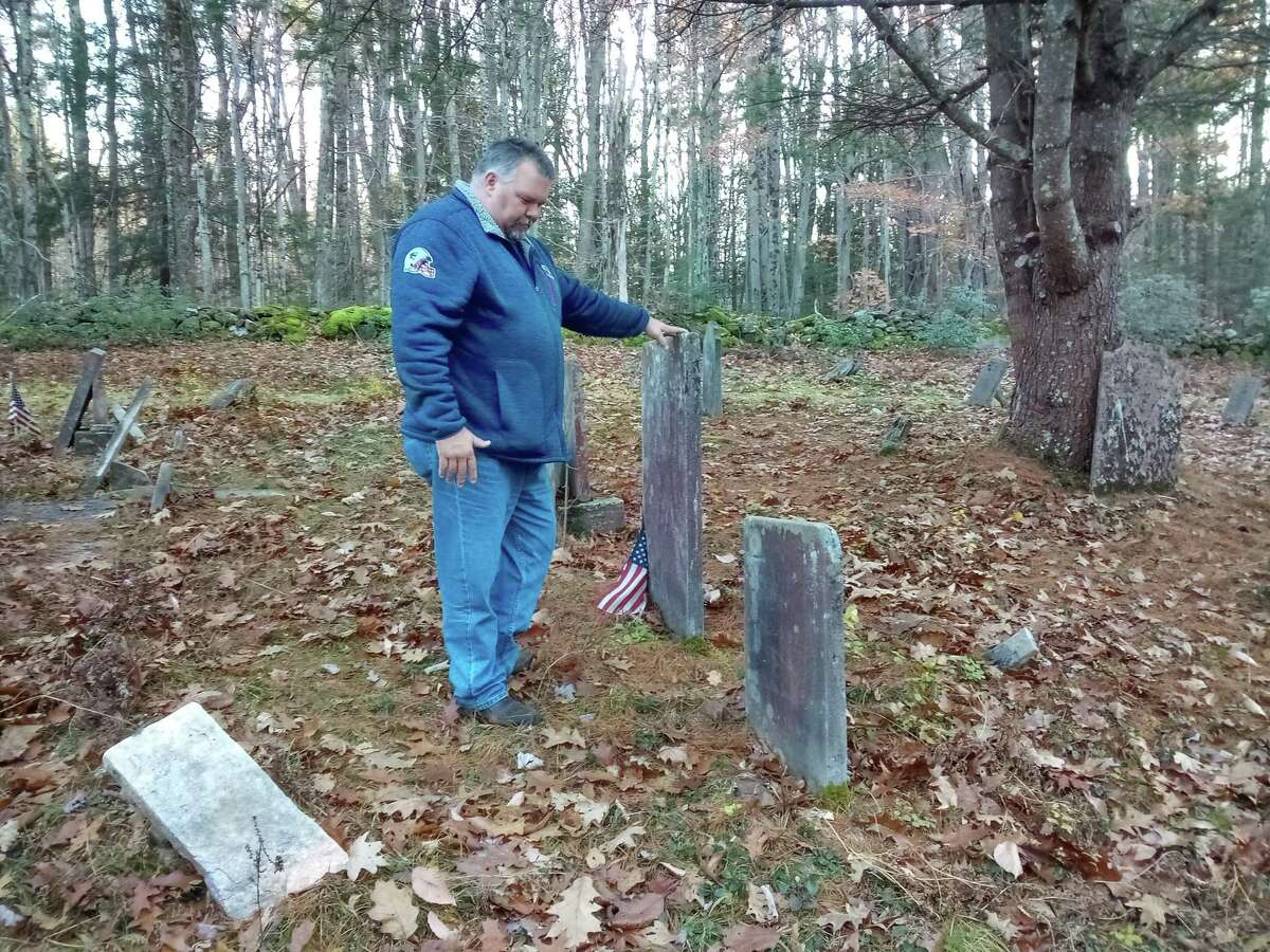 Winsted Mayor Todd Arcelaschi at the Danbury Quarter Road cemetery, one of the town's oldest burial sites near Winchester Center. It is inaccessible, mostly because of the condition of the dirt road, filled with potholes, standing water and deep ruts, as well as steep inclines. But the mayor wants to find a way to record who is buried there, clean up the one-acre property and possibly repair some of the many broken headstones.