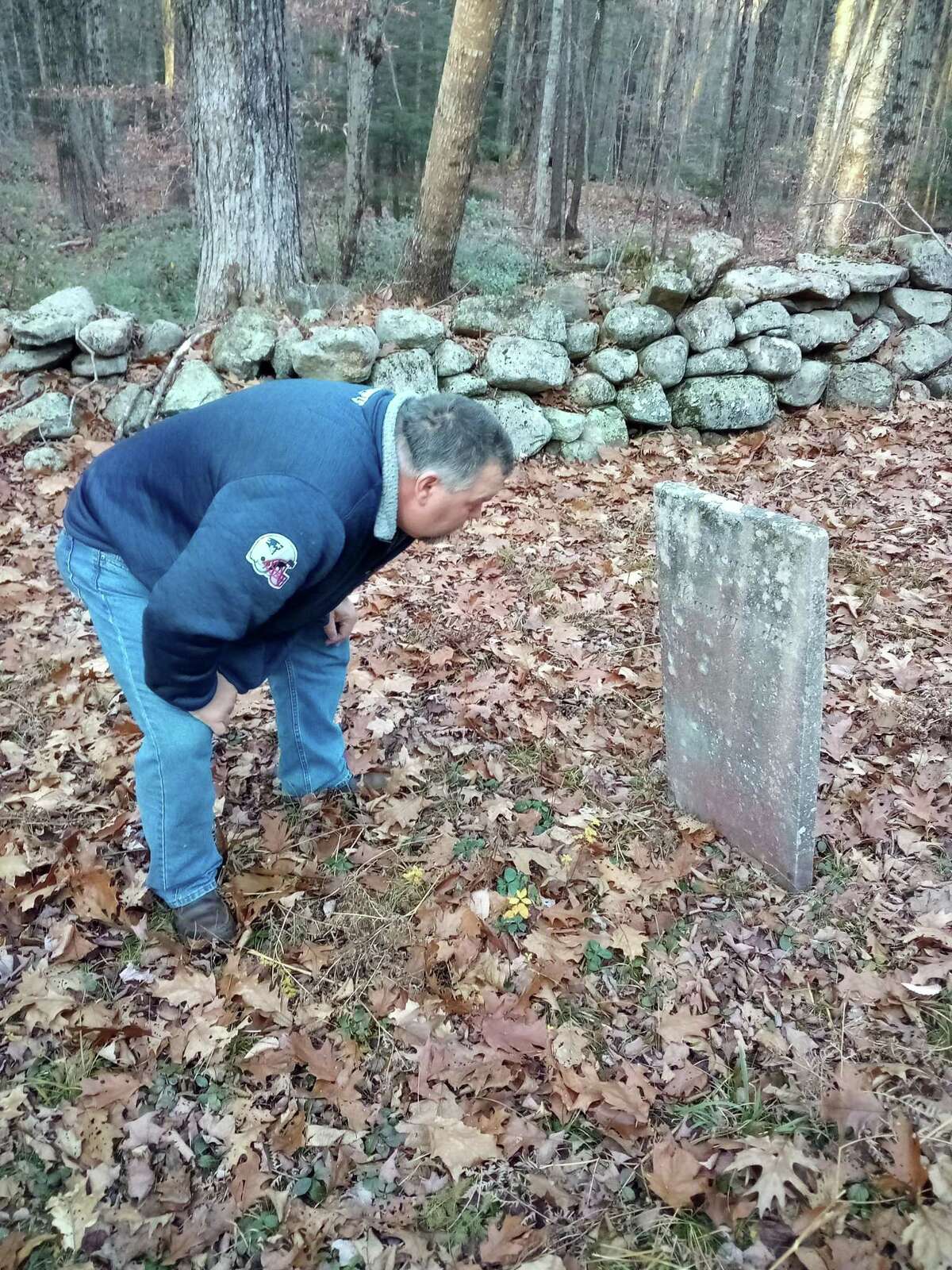 Winsted Mayor Todd Arcelaschi at the Danbury Quarter Road cemetery, one of the town's oldest burial sites near Winchester Center. It is inaccessible, mostly because of the condition of the dirt road, filled with potholes, standing water and deep ruts, as well as steep inclines. But the mayor wants to find a way to record who is buried there, clean up the one-acre property and possibly repair some of the many broken headstones.