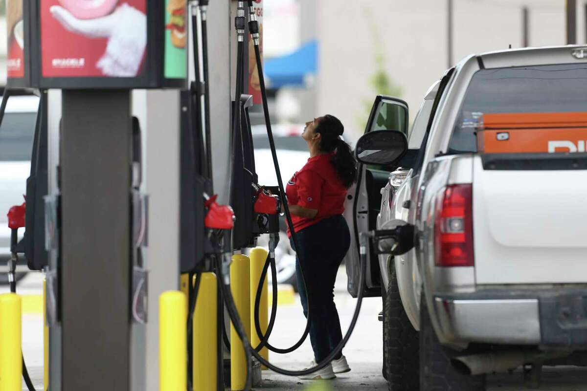A woman buy gasoline at a QuikTrip on SW Military Drive, Thursday, Nov. 18, 2021.