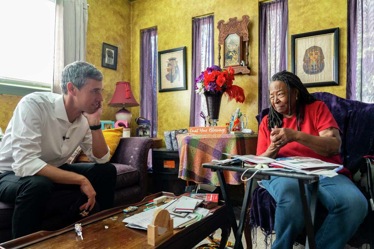 Sylvia Scarbrough laughs with gubernatorial candidate Beto O’Rourke as they talk about their Thanksgiving plans inside her Kashmere Gardens home, Friday, Nov. 19, 2021, in Houston. O’Rourke spent part of the afternoon visiting people in northeast Houston that lost power and had burst pipes during the freeze in February.
