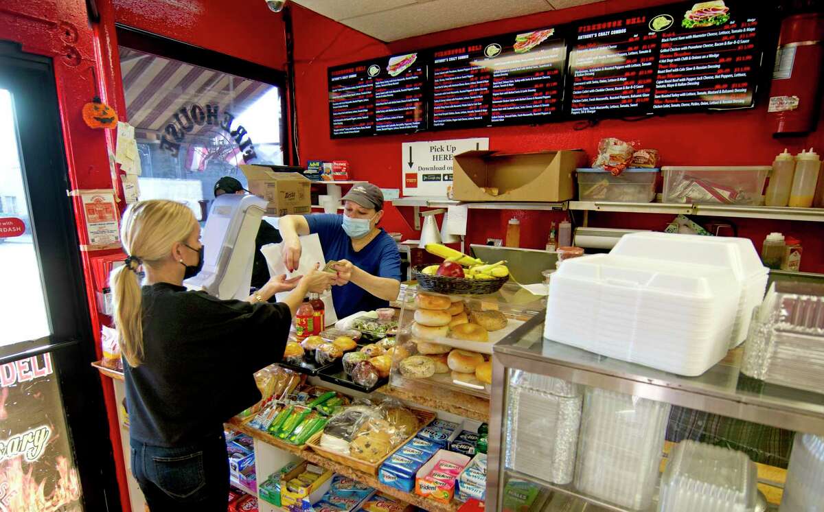 Veronica Gonzalez serves a customer at Firehouse Deli in the Byram neighborhood in Greenwich, Conn., on Thursday November 18, 2021. A revitalization of sorts is happening in the area, with new business and residential construction popping up.