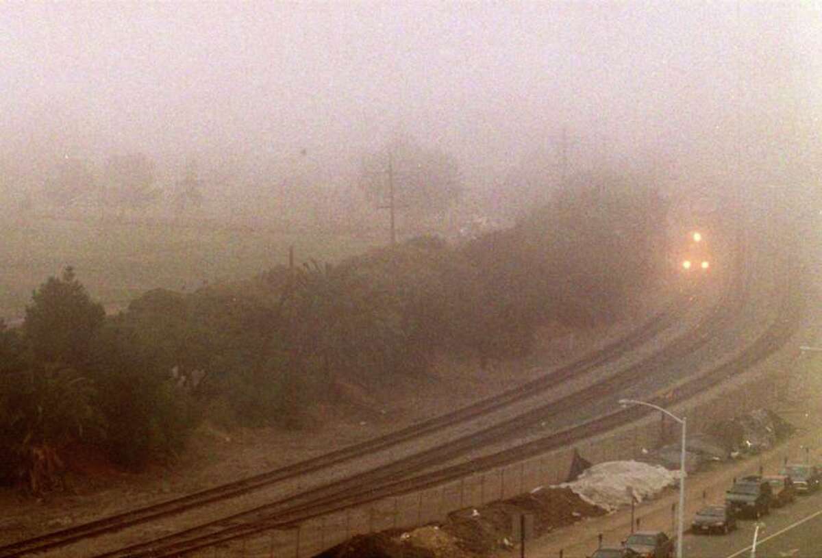 The headlights of a Union Pacific train in Martinez can barely be seen through a shroud of tule fog.