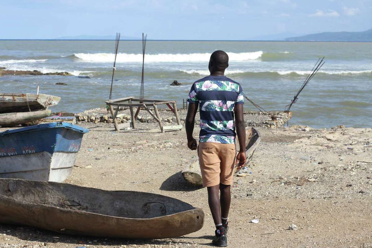 Jeff Pierre walks toward the sea Nov. 16 near where he lives in Jérémie, Haiti. He has already tried once to leave the country by boat and reach the United States because, he says, "This country does not offer me anything."