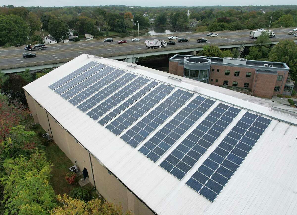 Solar panels are installed on the roof of the Greenwich Racquet Club in the Cos Cob section of Greenwich, Conn. Wednesday, Oct. 13, 2021. The Board of Selectmen’s Energy Management Committee has a goal of reducing the town’s energy consumption and costs by 20 to 40 percent through initiatives like LED bulbs and installation of solar panels through renewable energy credits.