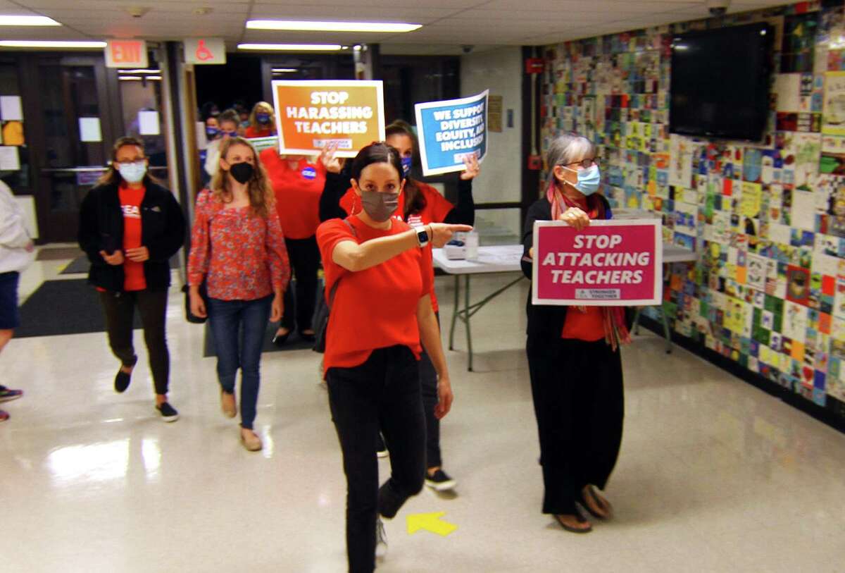 Educators, parents and students rally to End Attacks Against Teachers ahead of the Board of Education meeting at Central Middle School in Greenwich, Conn., on Thursday October 21, 2021. They are calling for an end to the recent attacks against teachers and the school curriculum.