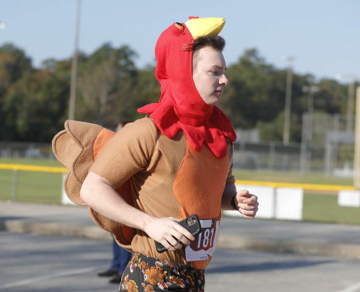 A runner wears a turkey-themed costume during Conroe's annual Turkey Trot at Carl Barton, Jr. Park.
