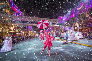 Performers dance with peppermint umbrellas during Bellevue's Snowflake Lane parade.