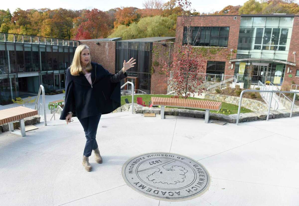 Head of School Molly King shows the courtyard of the newly renovated campus at Greenwich Academy in Greenwich, Conn. Tuesday, Nov. 11, 2021. Greenwich Academy just completed its $64 million renovation and expansion project, which includes a beautiful courtyard, visual arts center, atrium, dining hall, new lower school, and renovated middle school.