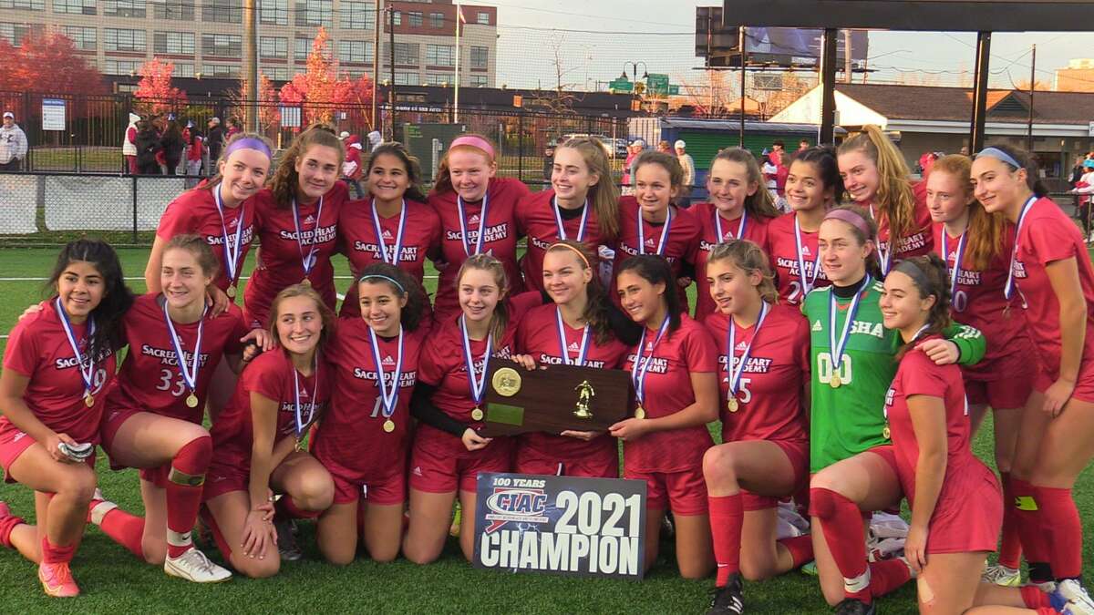 Members of the Sacred Heart Academy girls soccer team celebrate earning a share of the Class M state championship Saturday at Dillon Stadium.