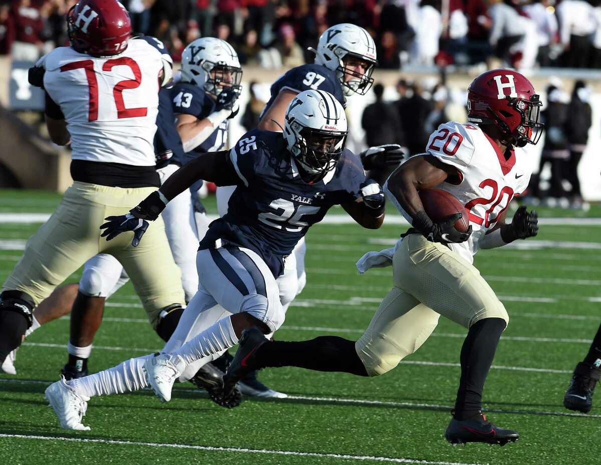 Aaron Shampklin of Harvard runs the ball against Yale at the Yale Bowl in New Haven, Connecticut, on November 20, 2021.