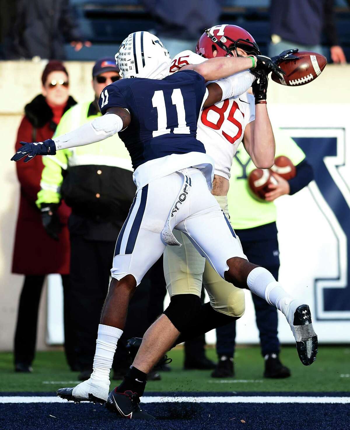 Dathan Hickey of Yale breaks up a pass intended for Adam West of Harvard at the Yale Bowl in New Haven, Connecticut, on November 20, 2021.